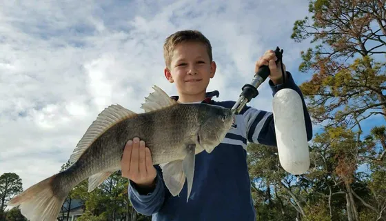 A family enjoying a fishing charter together in the Charleston creeks