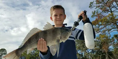 A family enjoying a fishing charter together in the Charleston creeks